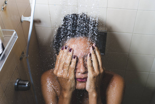 Portrait of a woman in the bathroom washing herself. Salvador, Bahia, Brazil. - Valokuva, kuva