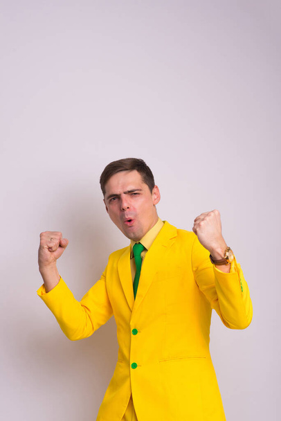 Portrét šťastného sebevědomého podnikatele ve žlutém obleku a kravatě, izolovaný na bílém pozadí. - Fotografie, Obrázek