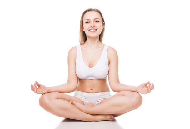 Young woman sitting in lotus position isolated - Photo, image