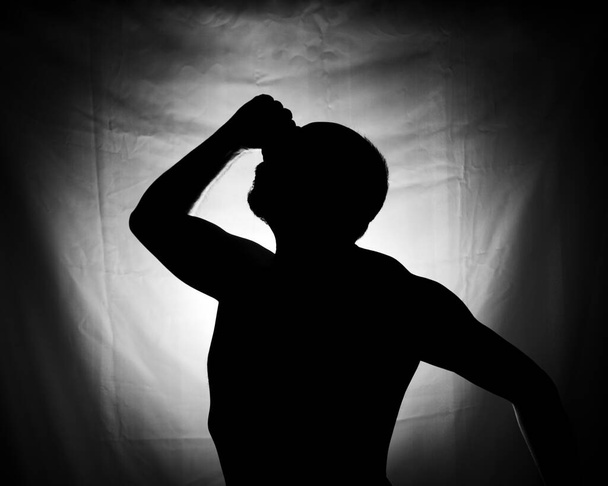 Black and white portrait in Silhouette of a man against white background. Salvador, Bahia, Brazil. - Фото, изображение