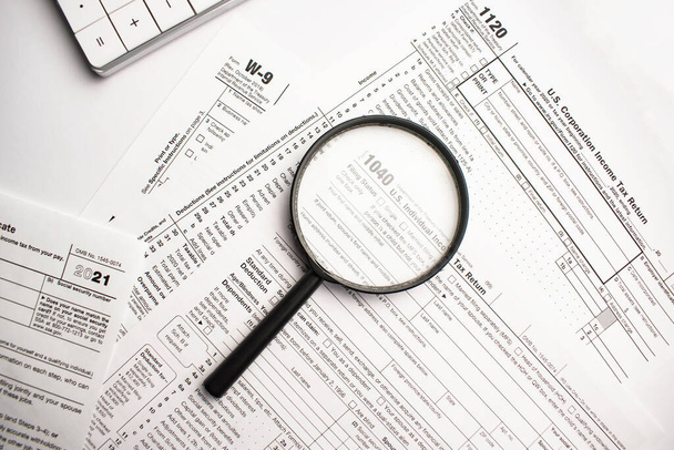 Tax Form 1040 with magnifying glass. Tax concept - Fotó, kép
