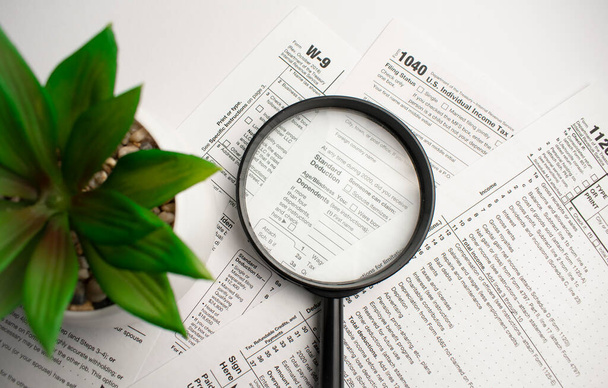 Tax Form 1040 with magnifying glass. Tax concept - Foto, Imagen
