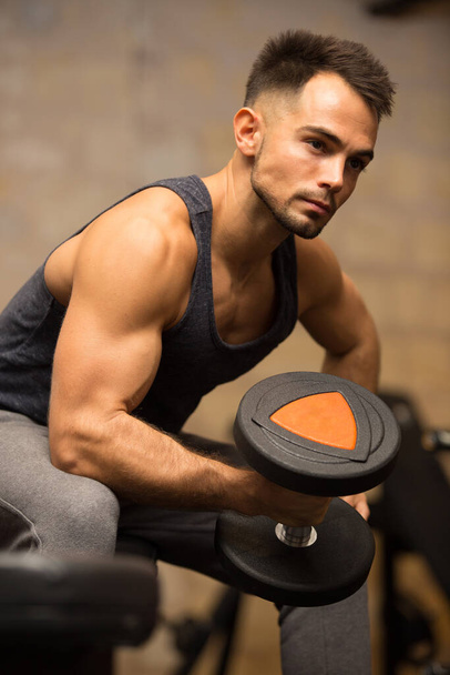 young guy carrying a dumbbell - Photo, Image
