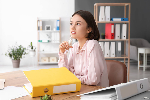 Young woman working with documents in office - Photo, Image
