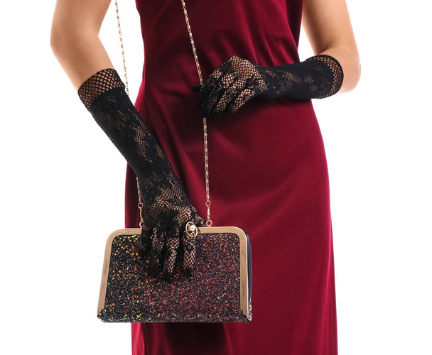 Elegant young woman with stylish gloves and bag on white background - Fotoğraf, Görsel