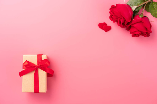 Giving present and celebration concept at Valentine's day, anniversary, mother's day and birthday surprise on pink background, copyspace, topview - Photo, image