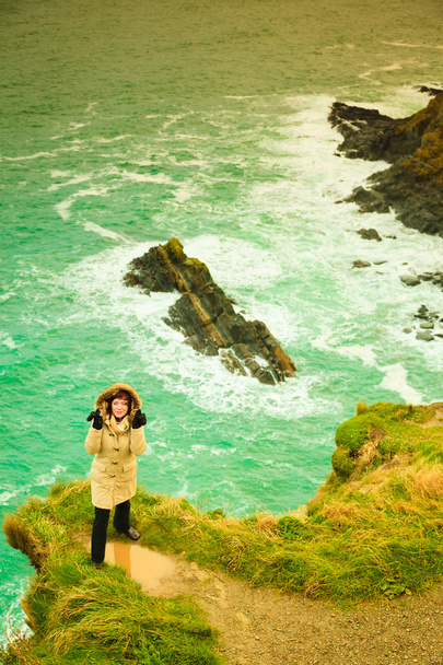 Woman tourist on rock cliff - Photo, Image