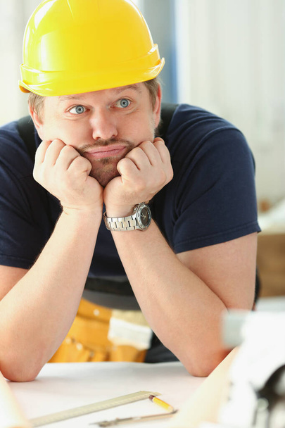 Worker man wearing architect hardhat thinking, looking bored and tired at construction site - Foto, Bild