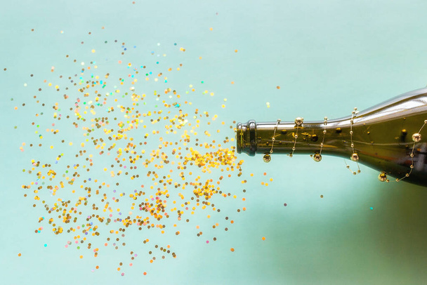 bottle of champagne and sparkles and confetti fireworks happy new year celebration - Fotoğraf, Görsel