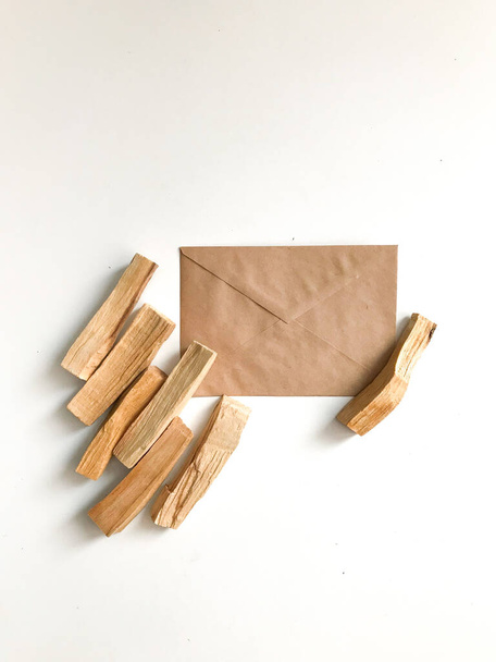 natural incense made of palo santo wood, aromatherapy. palo santo sticks and craft packaging on a white background, a place for text - Φωτογραφία, εικόνα