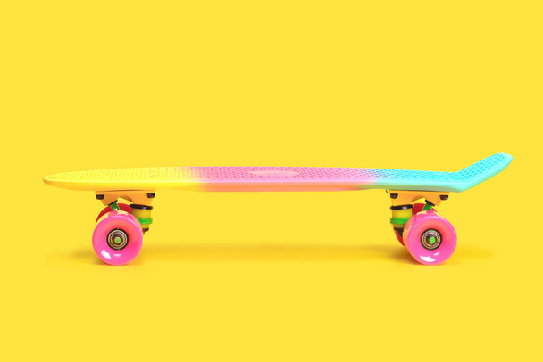 rainbow plastic Penny board skateboard isolated on yellow background - Photo, Image