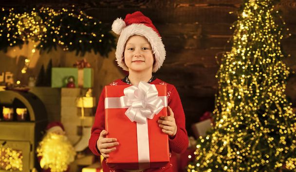 Holiday atmosphere. time to buy gifts. shopping sales. holiday preparation and celebration. small boy wear santa claus hat. christmas time composition. happy new year. kid wait for xmas presents - Foto, Imagem