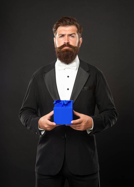 mature man in tux holding gift box, purchase - Фото, зображення