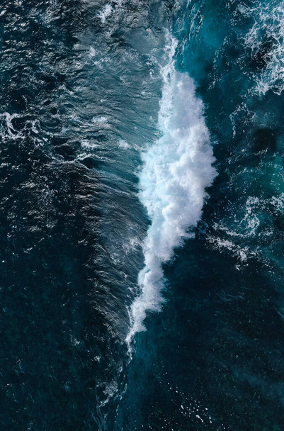 Aerial view to seething waves with foam. Waves of the sea meet each other during high tide and low tide - Φωτογραφία, εικόνα