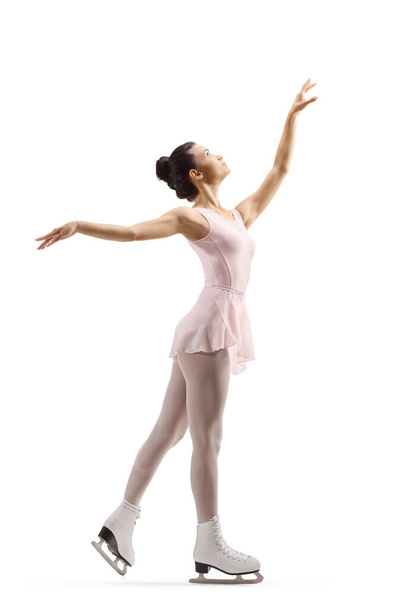 Full length profile shot of a young female performing figure skating isolated on white background - Φωτογραφία, εικόνα