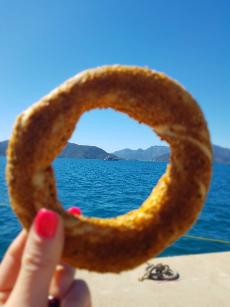 sea view Simit , traditional Turkish pastry food  Turkish street food circular bread, bagel with sesame. - Photo, Image