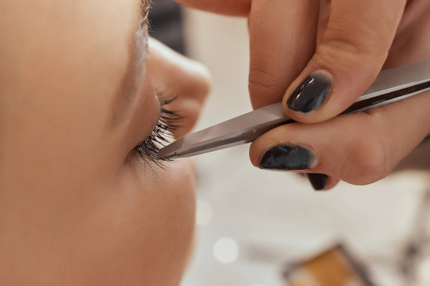 Eyelash Extension Procedure. Woman Eye with Long Eyelashes. Lashes. Close up, selected focus. - Foto, Imagen