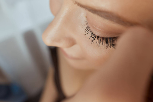 Eyelash Extension Procedure. Woman Eye with Long Eyelashes. Lashes. Close up, selected focus. - Photo, Image