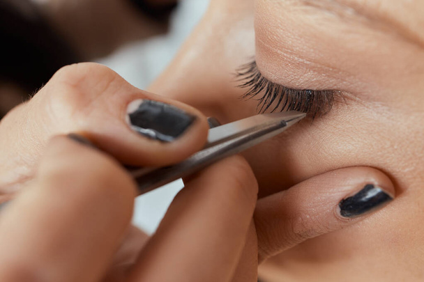 Eyelash Extension Procedure. Woman Eye with Long Eyelashes. Lashes. Close up, selected focus. - Фото, изображение