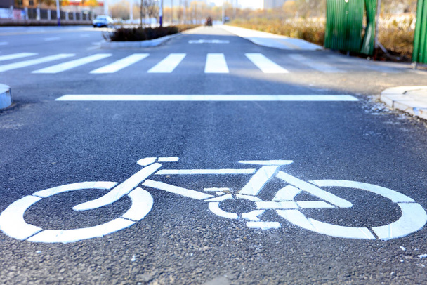Bicycle lane signage on a street, Bicycle signage on asphalt pavement - Photo, Image