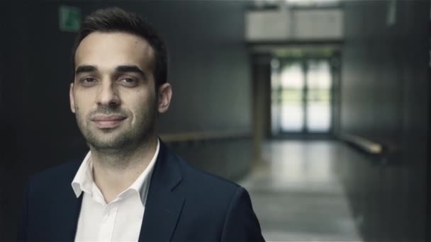 Portrait of handsome confident young businessman smiling looking at camera. - Záběry, video