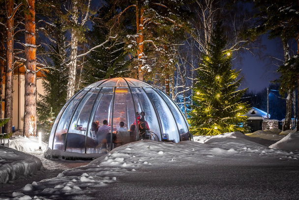 Dinner outdoors in a bubble in winter weather, lots of snow around to promote social distancing. - Photo, Image