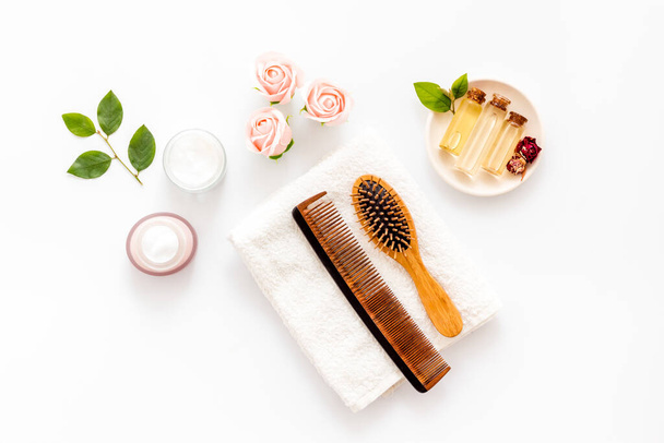 Flat lay of cosmetics for hair care with comb - Foto, imagen