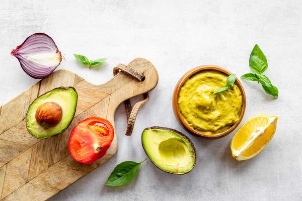Guacamole dip in bowl with avocado and lime - Photo, Image