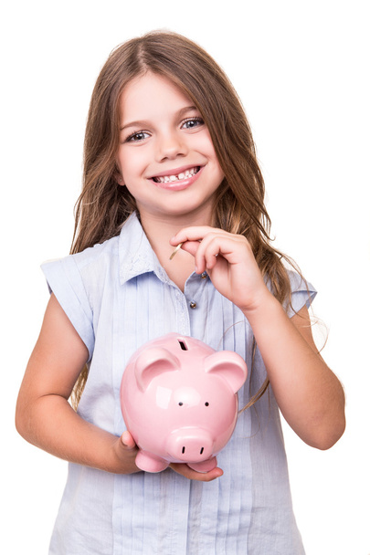Girl holding piggy bank - 写真・画像