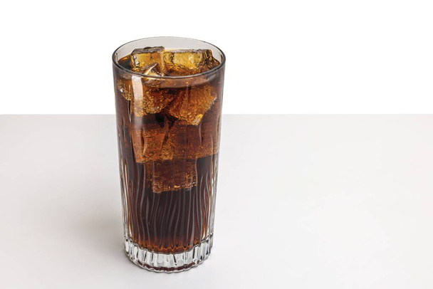 Beautiful view of soda drink glass with ice cubes isolated on background. Sweden. - Фото, изображение