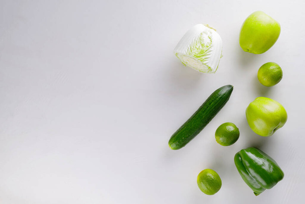 Different green vegetables and fruits on a white background. Healthy food concept. Top view. Copy space - Foto, Imagem