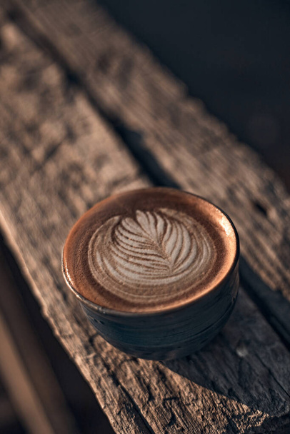 Selective focus cup of hot latte art coffee,focus at white foa - Фото, изображение