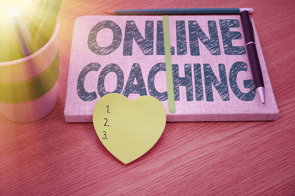 Inspiration showing sign Online Coaching. Concept meaning Learning from online and internet with the help of a coach Plain Blank Open Notebooks With Stack Of Pens Container Over Table. - Photo, Image