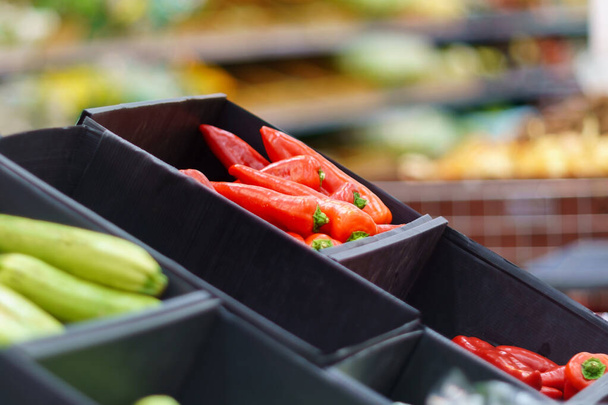Red pepper on the counter. Department in a store or supermarket with fresh products. Selective focus. - Foto, imagen