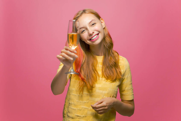 Young girl holding glass of champagne smiling, celebrating holiday, clink by bubbly, congratulate with xmas or birthday - Valokuva, kuva