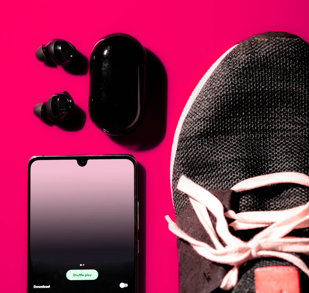 Flatlay of earphones running shoe and phone - Foto, Imagem