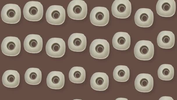 Colorful pattern of rolls of a white toilet paper isolated on brown background. Seamless pattern with toilet paper. Top view. Realistic animation. 4K video motion - Metraje, vídeo