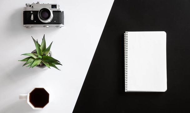 Vintage camera, coffee cup and notepad, flat lay. - Foto, immagini