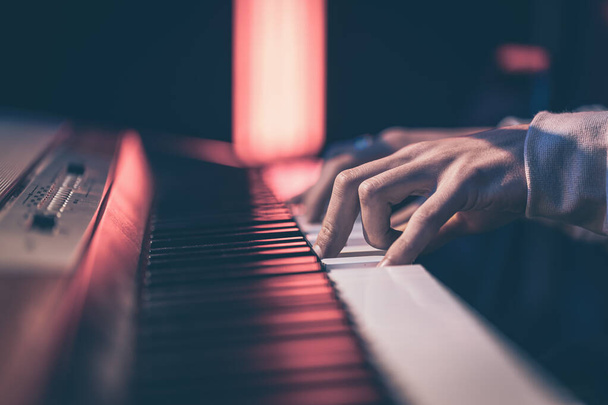 Close-up of male hands playing the piano keys. - Valokuva, kuva