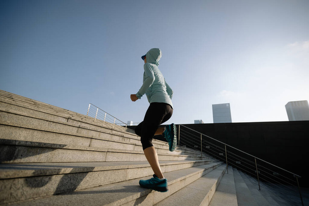 Fitness sports woman running up stairs in city - Foto, afbeelding