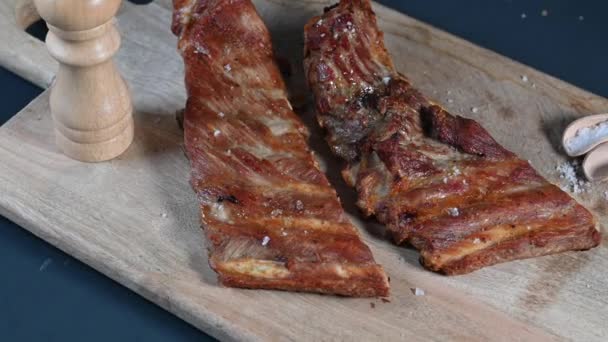 Baked Iberian pork rib on wooden background - Materiał filmowy, wideo