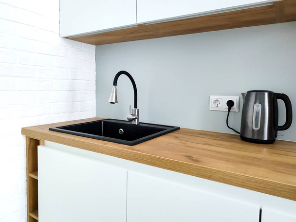 Black sink with flexible faucet in Scandi kitchen interior - Photo, Image