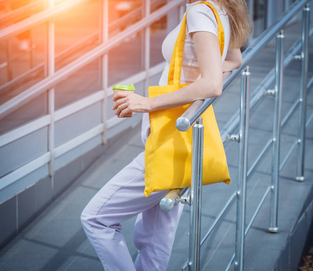 Young beautiful woman with linen eco bag on city background. - Foto, Imagem
