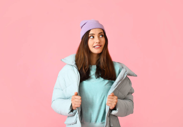 Pretty young woman in stylish warm clothes on color background - Фото, зображення