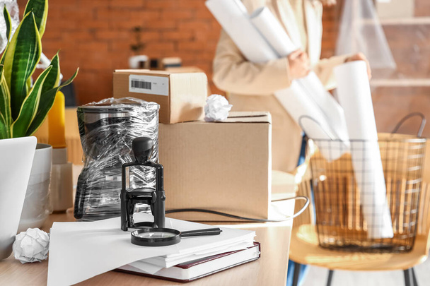 Cardboard boxes with belongings on table in office on moving day - Zdjęcie, obraz