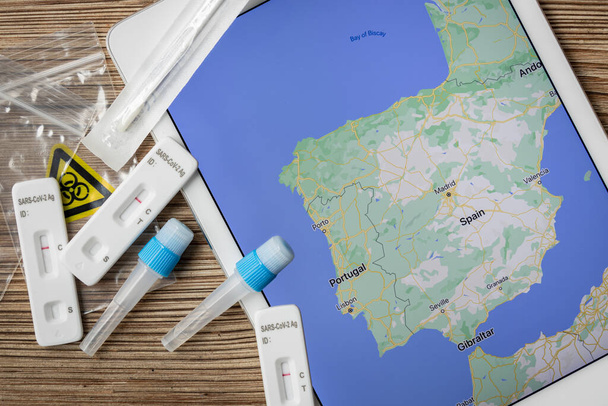 Covid home testing kits laying on a table next to a map of Spain and Portugal - Foto, Imagem