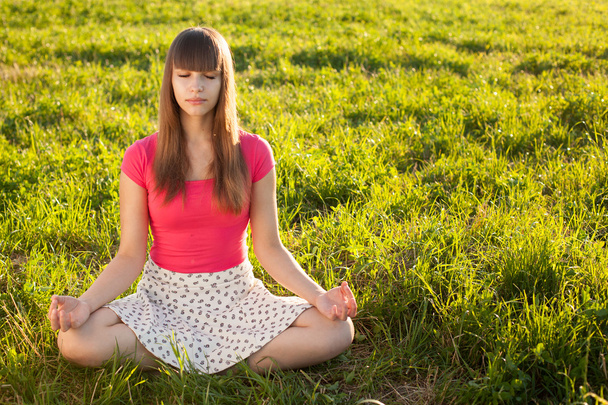 Beautiful young girl meditating - Photo, image