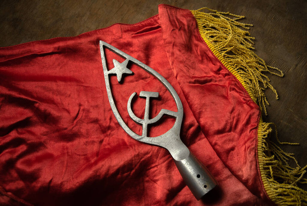 Hammer and sickle with a star on a red flag. A symbol of communism. Items from the Soviet Union. - Foto, immagini