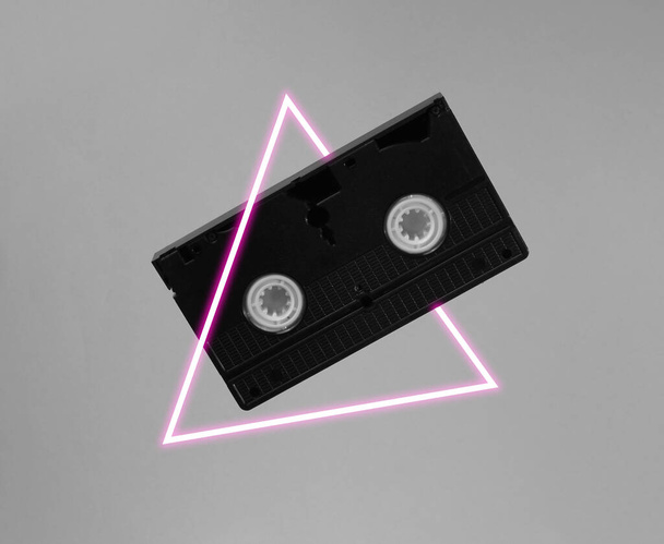 Video cassette. 80's synth wave and retrowave glowing triangle futuristic aesthetics. Old fashioned abstraction concept - Photo, Image