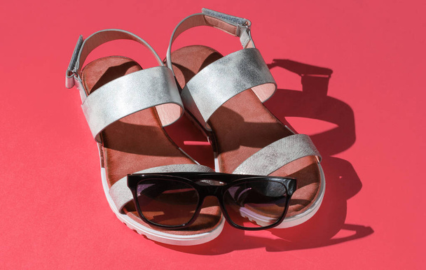 Fashionable women's sandals with sunglasses on pink background. Summer accessories - Φωτογραφία, εικόνα